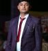 Man in a stylish suit standing confidently, exemplifying formal attire.